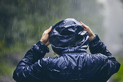 A picture of a person wearing a raincoat in the rain