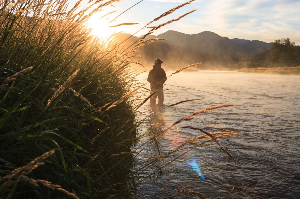 man fishing in a creek