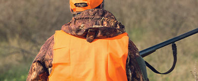 A hunter wearing an orange vest