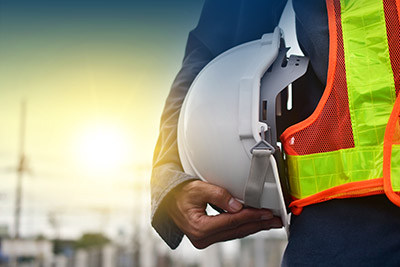 a construction worker holding a hard hat