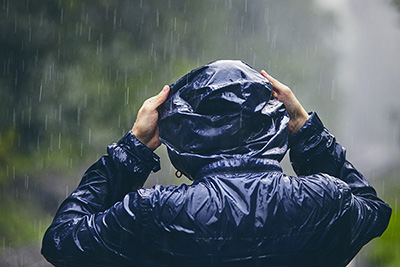 A picture of a person wearing a raincoat in the rain