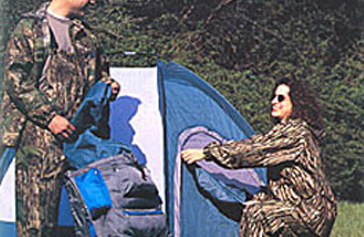 Two campers in camos setting up a tent