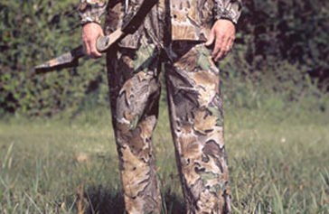 a hunter wearing camo rain pants
