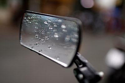 An image of a mirror with water droplets on it.