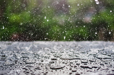 An image of a person riding a motorcycle in the rain